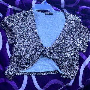 It’s a short sleeved, could tie in front or back, leopard print shirt.